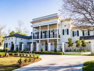 Photos by Thomas Building Company Greek Revival (New Orleans style) custom home features five bedrooms, 5 ½ bathrooms, and is located in the very sceni