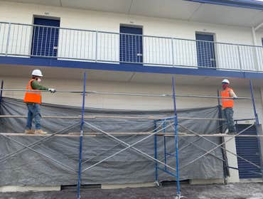 Men On The Move-Farmingdale Repaired damaged catwalks (top and bottom). Applied waterproofing, and painted to restore the original blue and white look.