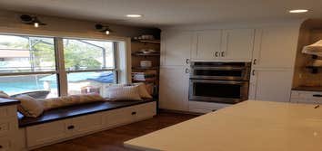 Photos by Jmc Builders Group LLC #1 Complete tear out and remodel with white shaker cabinets , custom oak shelving and bench