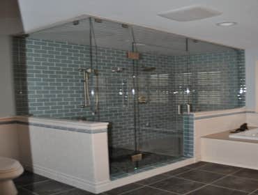 Beautiful Sea Foam Glass Tile with Clear Glass Surround and Pebble Floor