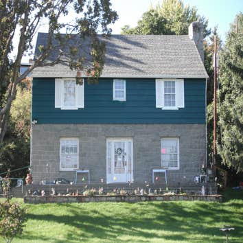 Stone House Remove cabinets and window, add wall closet to bedroom, install sliding door, tile on inside of slider, add secound story deck to front of 