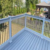 New Build: Trex Enhanced Decking with White Vinyl Railing New deck build with Trex Enhanced decking boards and Vinyl railing with black round aluminum 