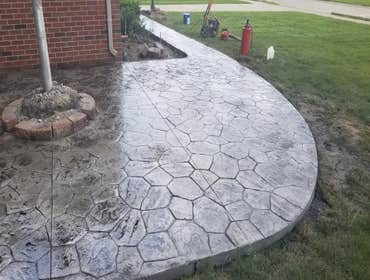 Photos by Guevara Alexander #1 A curated collection of our high-end residential concrete work, including stamped patios, exposed aggregate driveways, w