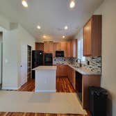 Photos by KormexLLC Kitchen/Living room before/after Refinishing cabinets from an old oak stain to a two tone color scheme. Adding a glass face to a ca