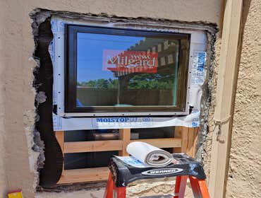 Installation of a new awning window with stucco exterior finish