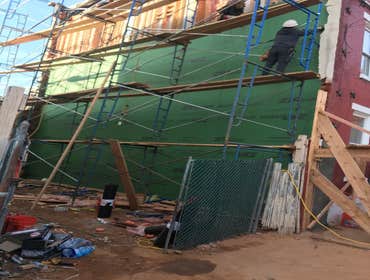 Remove unsafe exterior foundation wall and rebuild it.