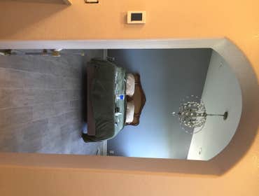 Custom master bathroom with custom tiled backsplash above vanity