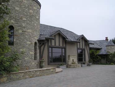Exterior limewash on plaster with raised trim faux finished to resemble wood