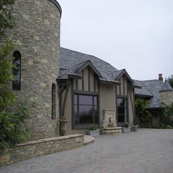 Exterior limewash on plaster with raised trim faux finished to resemble wood