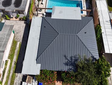 Photos by Gold Star Miami Corp #1 metal roof panels all are . 25 years warrantee