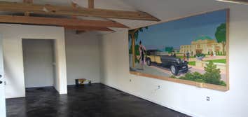 Stained concrete 1940s signal car garage converted to man cave pour concrete floor level famed and plumbed toilet and shower ,isolated roof and walls 