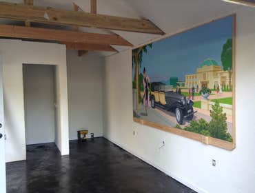 Stained concrete 1940s signal car garage converted to man cave pour concrete floor level famed and plumbed toilet and shower ,isolated roof and walls 