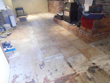 Basement tile floor 600 sq. ft. 18X18" tiles offset pattern. Flooding destroyed floating floor in this basement. Installed 18" porcelain tiles offset 