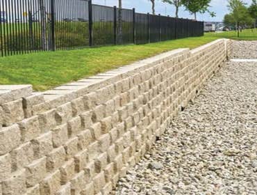 Stone Retaining Wall and Stairs We built this beautiful stone retaining wall with stairs that look grand!