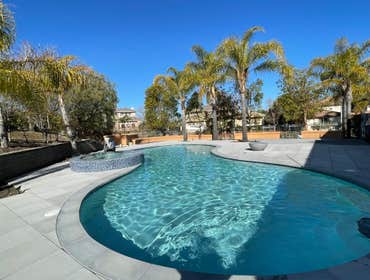 Outdoor living by Oria Builders Reduce pool depth, and redesign the entire outdoor living, including paving, patio, outdoor kitchen, patio cover and mo