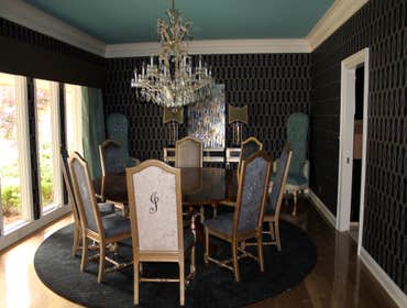 Project photos from Cmi Construction Remodel featuring dining room and entry to home. Hardwood flooring in dining area with new wallpaper and painted 
