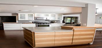 Brobst Kitchen Modern lines with horizontal hickory cabinetry, stainless steel counter tops, copper apron front sink. Blended with traditional white c
