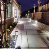 Photos by A Y & Sons Landscape & Design #2 New paver driveway, putting green, lighting and seat walls