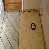 subfloor 1 Rotted subfloor from leak on toilet. Removed to joists, rebuilt to hall floor, linoleum sloped to rise at wall, reinstall all plumbing.