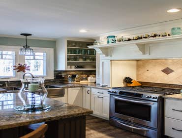 Meadville Two Tone This is a beautiful kitchen with Aurora White Perimeter Cabinets and Two Cherry Islands. All work from design to install of everyth