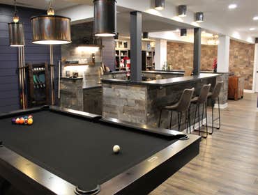Basement renovation with a western style home bar like a rustic tavern