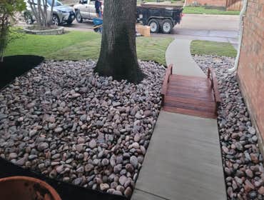 Photos by Alexsander Deoliveira Franca #1 multi-colored river rock new concrete walk way with wood bridge