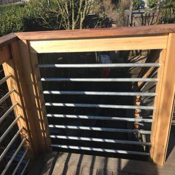 Modern Deck Project Replace existing deck and add square footage, update look of railing to match building aesthetic
