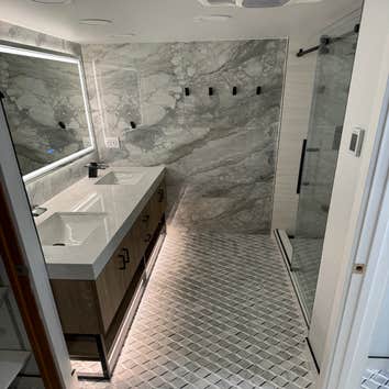 Luxury bathroom with under cabinet lighting and heated floors