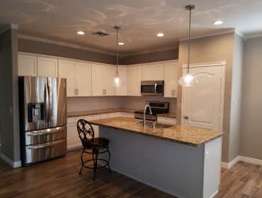 Kitchen remodel after pic/ custom can lighting/ appliance install/ plumbing/ custom flooring/ pendant lights