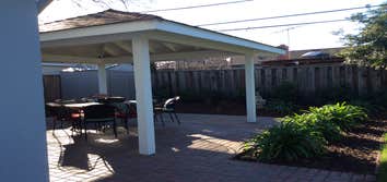 600 sf covered gazebo w pavers and lighting - making use of a corner in a huge garden