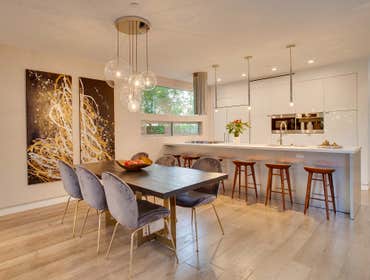 Sleek Minimalistic Kitchen Remodel The kitchen design embraces an ultra-modern style, featuring sleek white lacquer cabinetry. It is meticulously equip