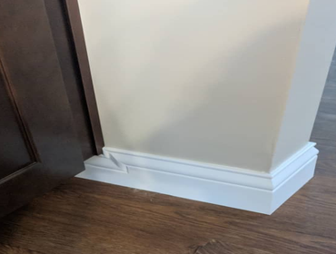Photos by Duckett Carpentry #7 Client wanted wider baseboard but didn't realize that it would leave a nasty look by the cabinets. We make it look elega