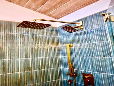 Photos by Ma Properties Construction #1 This bathroom remodel transformed an outdated space into a modern, functional retreat. The project included a c