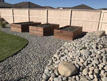 Photos by Enova Renovation #2 Removed grass in north back corner, compacted top soil, installed liners, flower boxes and river rock at desired levels.