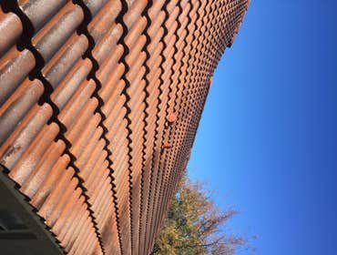 Photos from Popa Construction LLC Before & Afters of a soft wash roof cleaning and driveway and side walk cleaning.