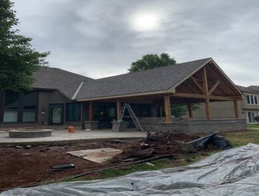 Large cedar covered patio Covered patio attached to existing house. Existing hipped roof had to be turned into a 12/12 pitch gable before we could sta