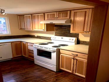 Quartz Kitchen This full kitchen remodel included quartz countertops, a glass tile backsplash, hood range, sink, faucet, dishwasher and custom designed