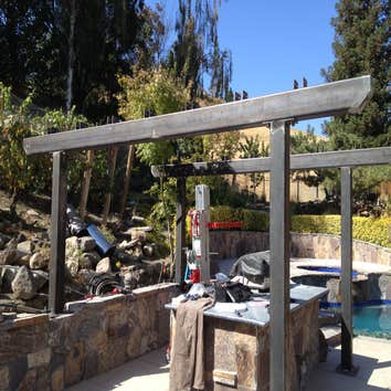 Powder Coated Steel and Painted Redwood Pergola Beams and posts were fabricated from steel then powder coated white. Redwood was milled down and finish