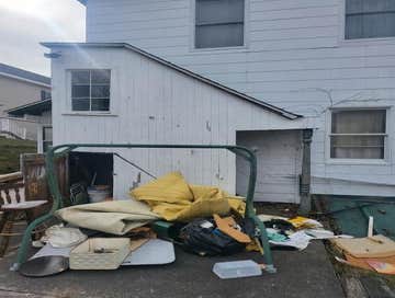 Photos by Reaper Junk Removal Services #5 Demoed rear porch with attached roof and covered stairs.