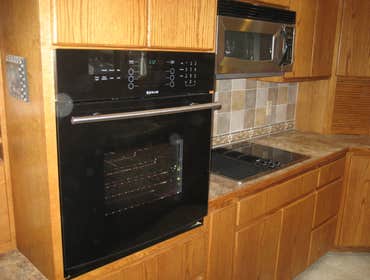 Olympia Kitchen Renovation A project including new vinyl flooring, appliances, laminate countertop surfaces, new oak trim, complete cabinet cleaning, r