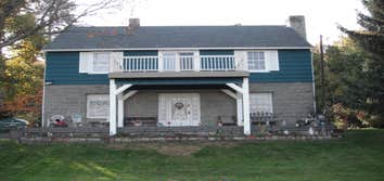 Stone House Remove cabinets and window, add wall closet to bedroom, install sliding door, tile on inside of slider, add secound story deck to front of 