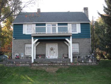Stone House Remove cabinets and window, add wall closet to bedroom, install sliding door, tile on inside of slider, add secound story deck to front of 