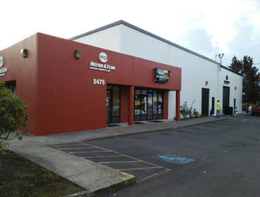 Exterior painting on a Commercial building Exterior Painting: changing to a new color to bring more joy to their business