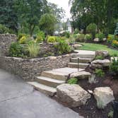 Hillsdale, NJ Complete Front Landscape Reno The stacked stone walls and slab steps replaced existing crumbling poured concrete walls, steps and walkway