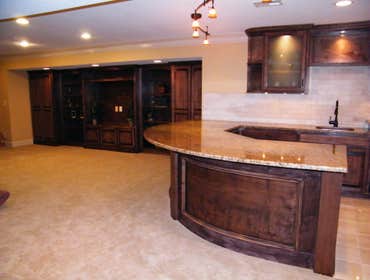 Basement Finishing Project Basement Finish in Overland Park featuring a radius wet bar.