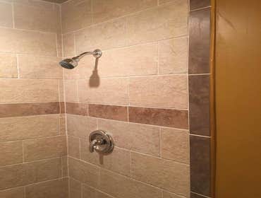 Photos by Cornerstone & Son Construction LLC #6 Recessed shelves were removed to create a larger shower stall. Tile was installed in staggered pattern