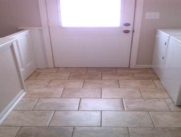 First Floor Laundry Room Painted cabinetry and ceramic tile floors turn a previously unused space into a convenient laundry room.
