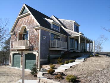 Photos by Thomas F Maroney Jr #4 Challenging Lot 164 feet above conservation bogs and large water/lake. Four bedroom four baths.