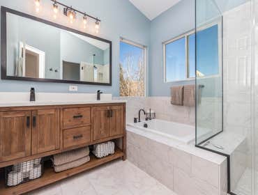 Master bathroom remodel To remodel this master bathroom, we replaced all finishes, including a new vanity, tile, and glass shower enclosure. We also re