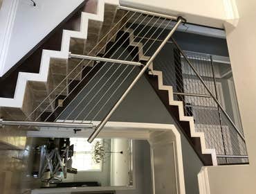Photos by Brainz & Brawn Structures Inc #1 Stainless Steel bar handrail.. multi-tier stainless railing for interior staircase and basement access.